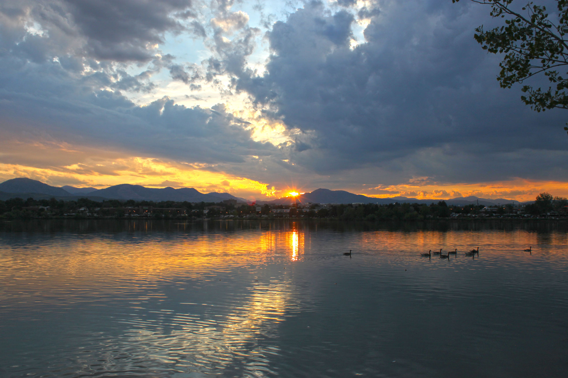 Sunset views of Johnston Reservoir with mountains int he background in Clement Park