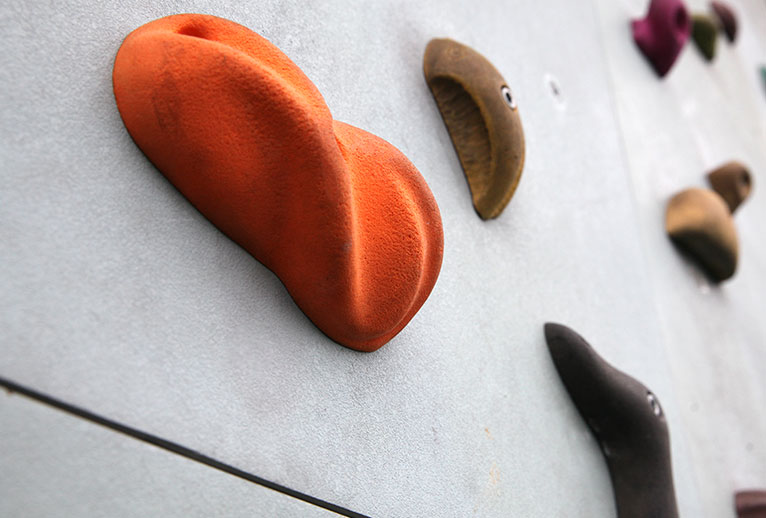 Close up image of holds on a climbing wall.