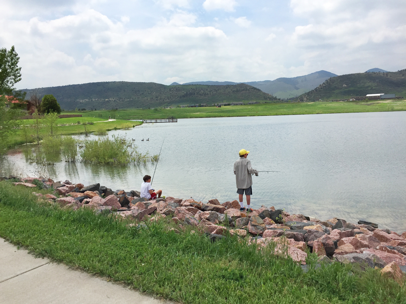 Two boys fishing at Hine Lake in Easton Regional Park.