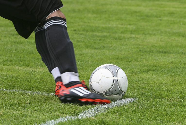 Soccer player kicking a ball.