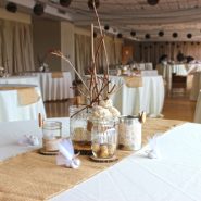 A wedding reception with round dining tables and chairs