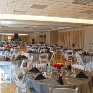 A wedding reception with round dining tables and chairs