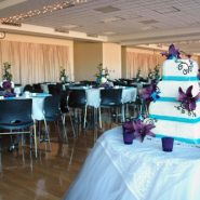 A wedding reception with round dining tables and chairs