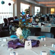 A wedding reception with round dining tables and chairs