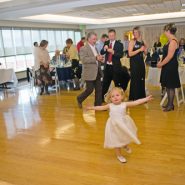 A little girl dances during a wedding reception
