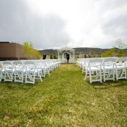 An outdoor wedding ceremony set up on grass
