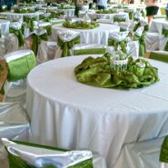 A wedding reception with round dining tables and chairs