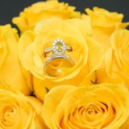 Wedding rings nestled in the middle of a yellow rose bouquet