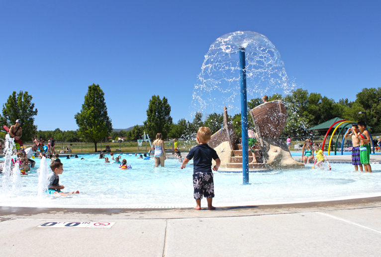 People playing in an outdoor pool.