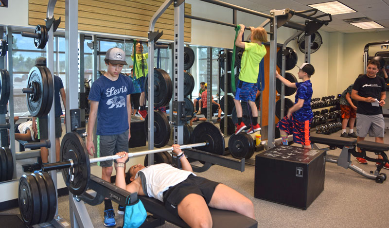 strength conditioning 1 A group of teens in a sport performance training class with a fitness trainer.