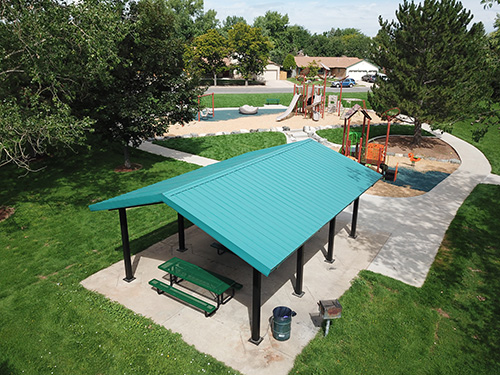 Playground features and park shelter at Blue Heron Park