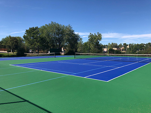 Tennis courts at Dakota Station Park on a sunny, blue sky day..
