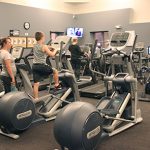 A mom and son exercising on the cardio weight equipment in the cardio weight room in Lilley Gulch Recreation Center.