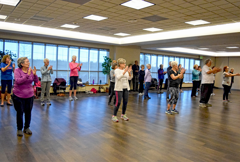 A class full of participants doing tai chi.