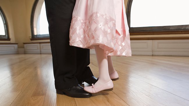 Little girl dancing with her dad