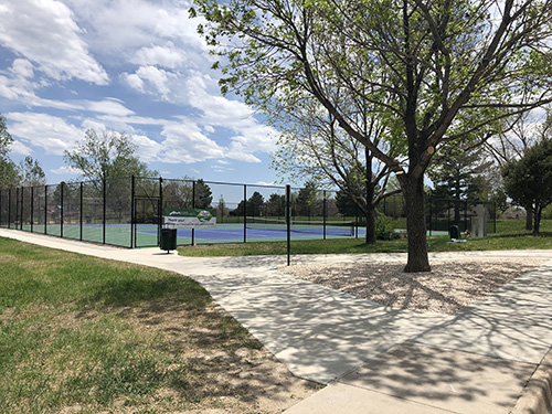 Sidewalk view of the tennis courts at Dakota Station Park.