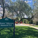 View of park sign and sidewalk entry at Dewy Haberman Park