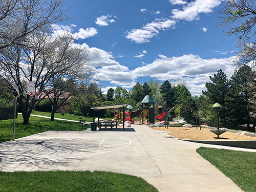 View of playground, shelter and basketball court at Dewy Haberman Park