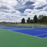 Tennis courts at Lilley Gulch Park with mountain views in the background.