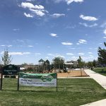 Street entry view of Trappers Glen Park showing playground and sidewalks in background.