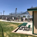 Outside view of the batting cages showing picnic benches for spectators.