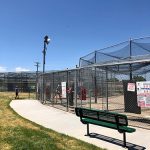 Outside view of the batting cages showing a bench for spectators.