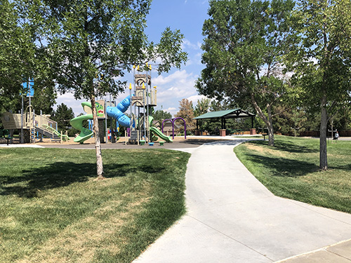 Sidewalk view leading to the playground and park shelter in Chaucer Park.