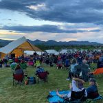 Crowd of people attending a concert at the Grant Amphitheater in Clement Park