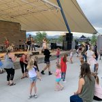 Crowd of people attending a concert at the Grant Amphitheater in Clement Park