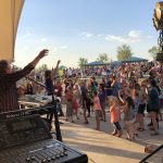 Crowd of people attending a concert at the Grant Amphitheater in Clement Park