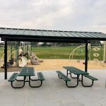 View of park shelter in Valley View Park with playground in background.