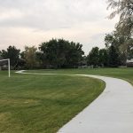 Sidewalk meandering through green grass in Valley View Park