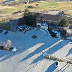 Overhead drone image of the parking lots at Meadows Golf Club including the clubhouse and portions of the nearby course.