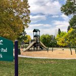 Scenic view of Lilley Pad Park showing the park sign, playground pretty fall colors on many surrounding trees.