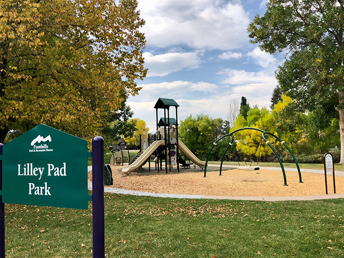 Scenic view of Lilley Pad Park showing the park sign, playground pretty fall colors on many surrounding trees.