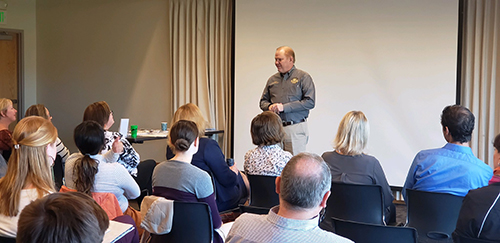 SJBA Sheriff Jefferson County Sheriff giving a presentation to a group of business leaders.
