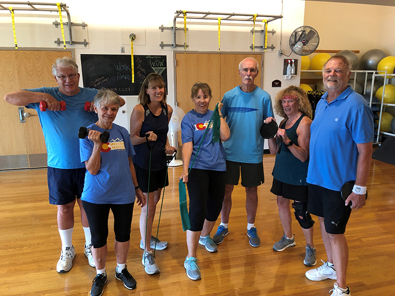 A group of active senior adults posing after a fitness class