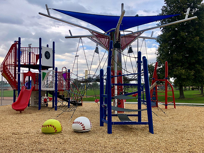 Baseball themed playground near a ballfield.