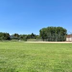 After project shot of Columbine Sports Park with green, groomed grass field and ballfield.