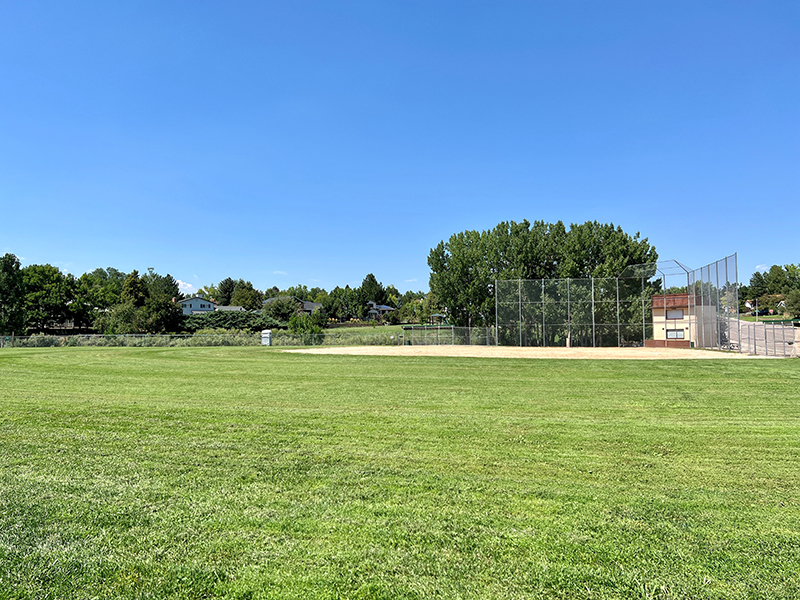 After project shot of Columbine Sports Park with green, groomed grass field and ballfield.