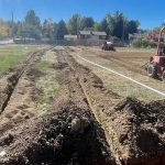 Before shot of Columbine Sports Park showing trenches in turf preparing to lay new irrigation lines.