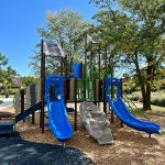 Playground in Victory Park with two blue slides and other play features.