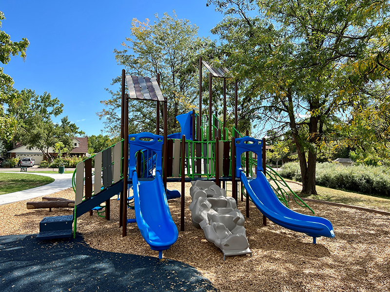 Playground in Victory Park with two blue slides and other play features.