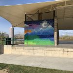 Colorful, painted wall showing the moon behind the mountains