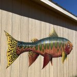 The side of a shed painted with a realistic looking cutthroat trout