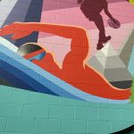 Close up of the section of artwork displaying the silhouette of a swimmer
