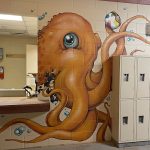 An orange octopus painted around the front desk and lockers inside the bath house