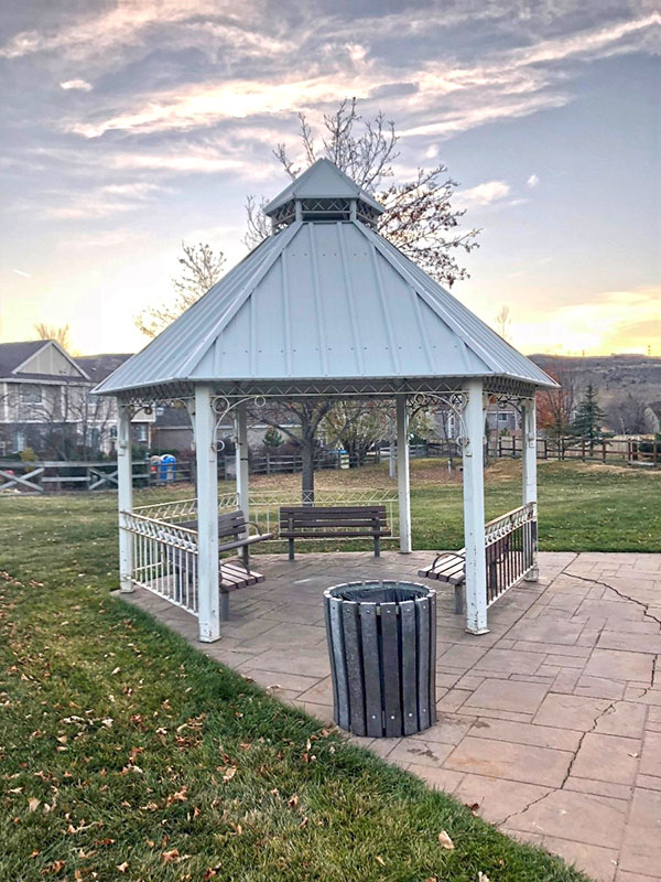 A quaint gazebo with benched placed underneath