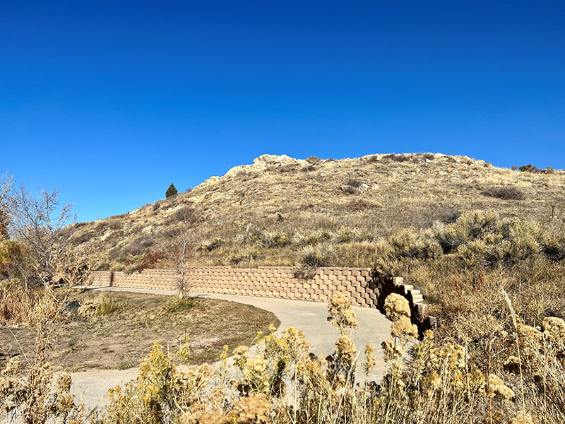 A meandering sidewalk leading up toward a hill