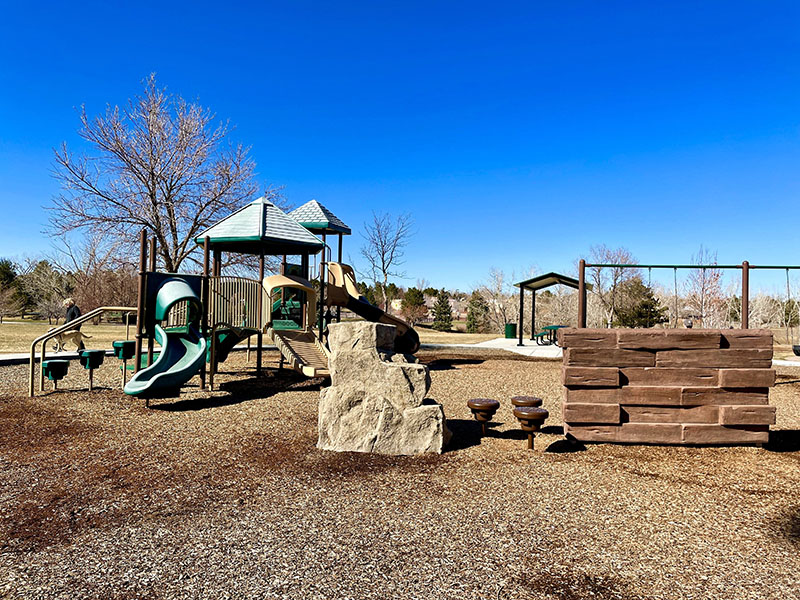 View of playground with picnic shelter and sidewalks
